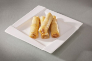 Spring rolls stuffed with vegetables and cheese, with ginger sauce